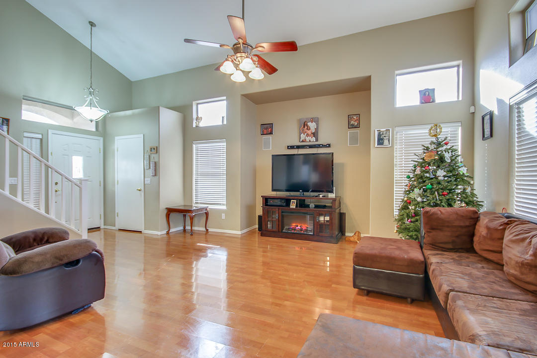 5362 West Pecan Road Laveen, AZ 85339 - Photo 6 of 28 a living room with furniture a flat screen tv and kitchen view
