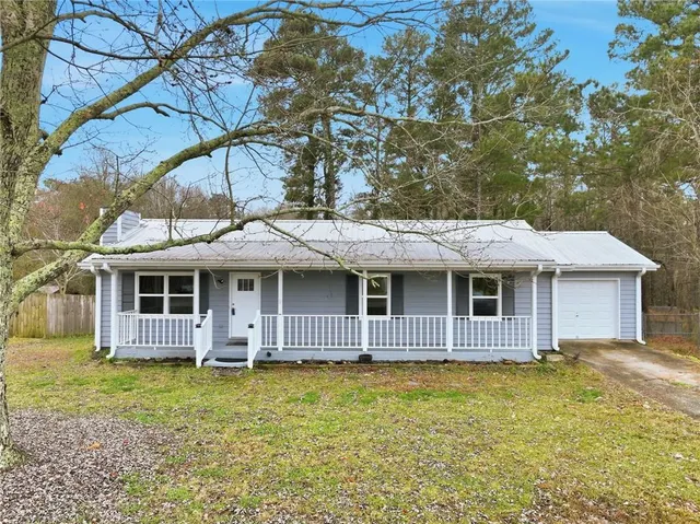 a view of a house with a backyard