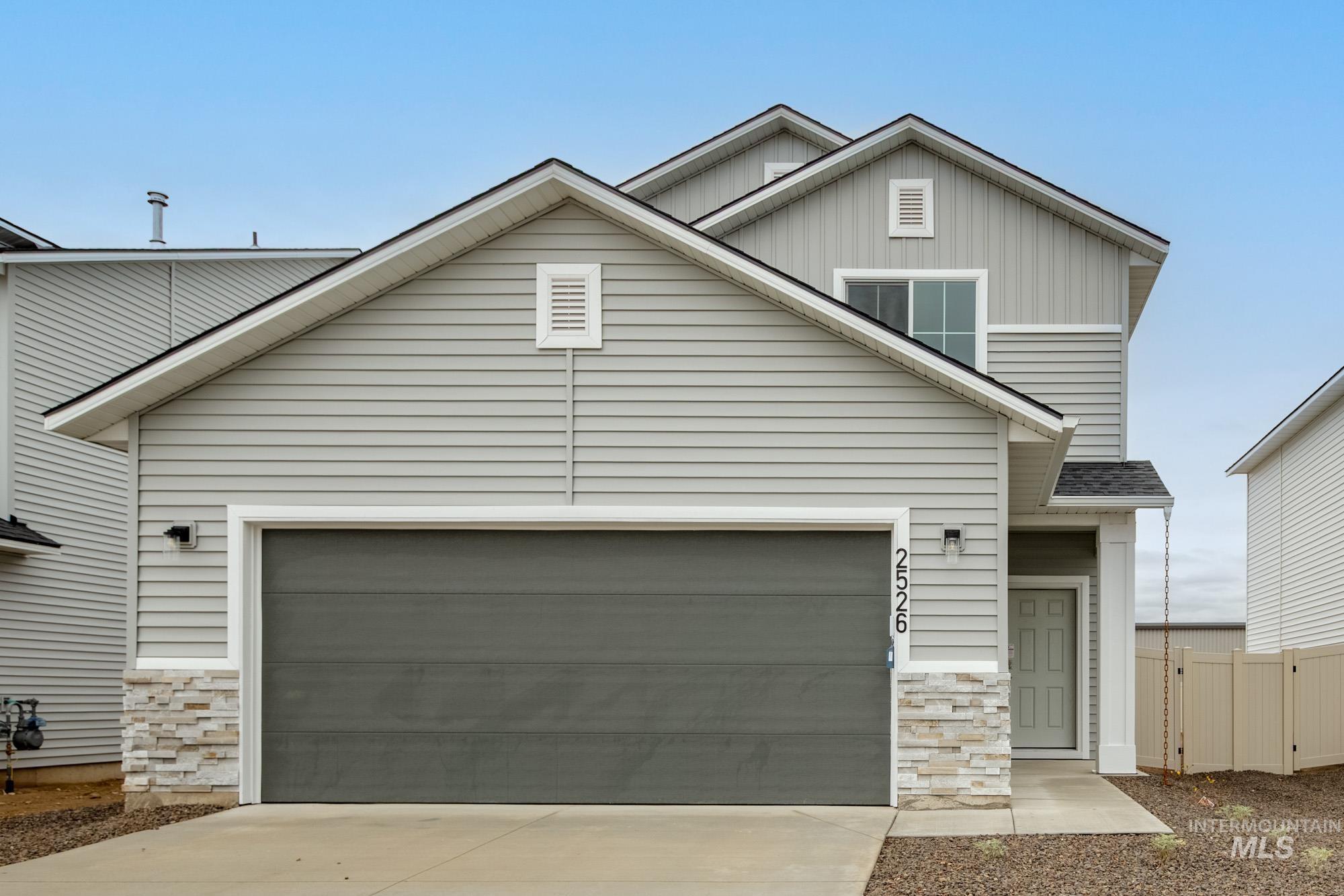 2526 West Fallon Loop Nampa, ID 83651 - Photo 1 of 32 View of front of home featuring driveway, board and batten siding, an attached garage, and stone siding