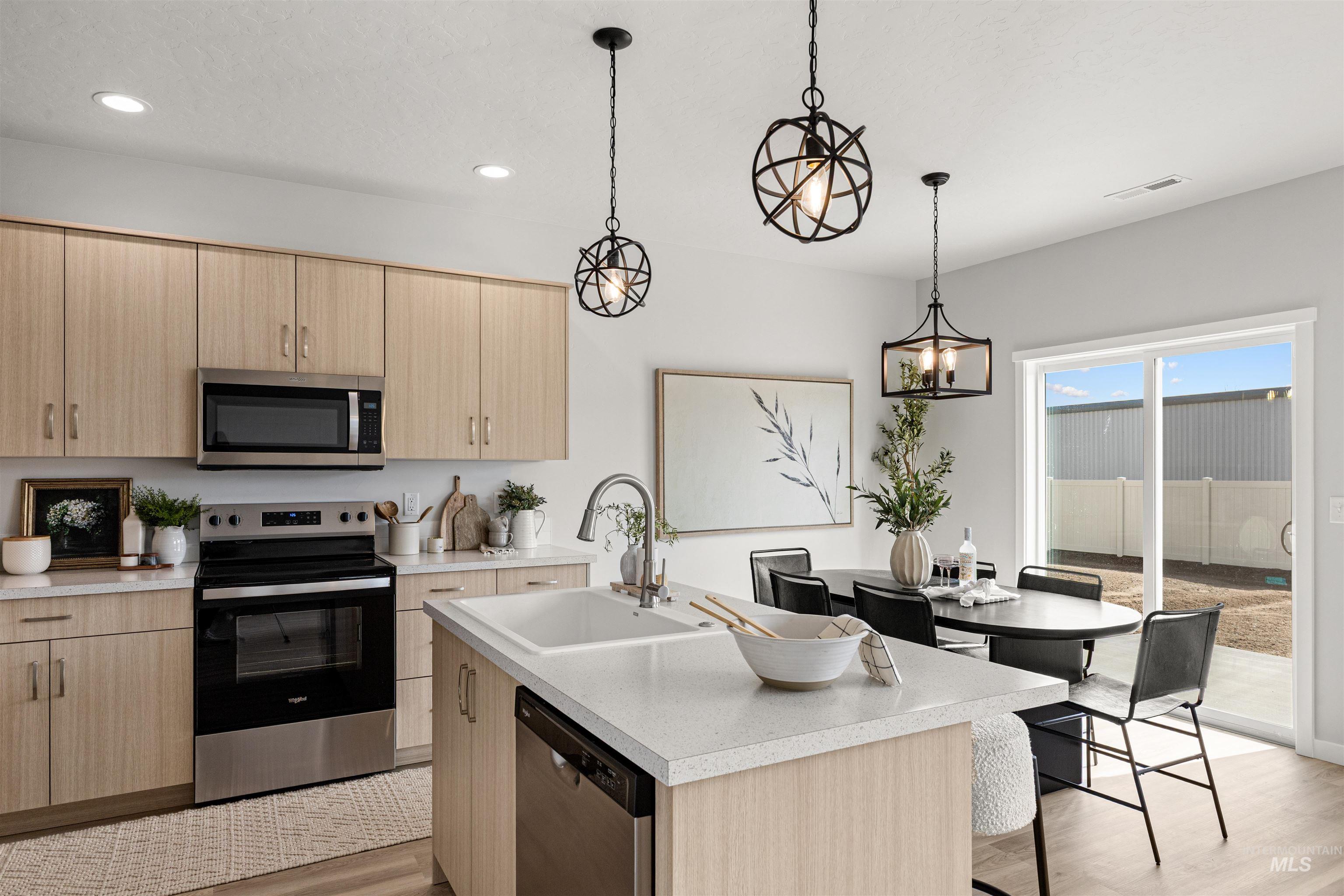 2526 West Fallon Loop Nampa, ID 83651 - Photo 11 of 32 Kitchen featuring stainless steel appliances, light wood finish cabinetry, and light countertops