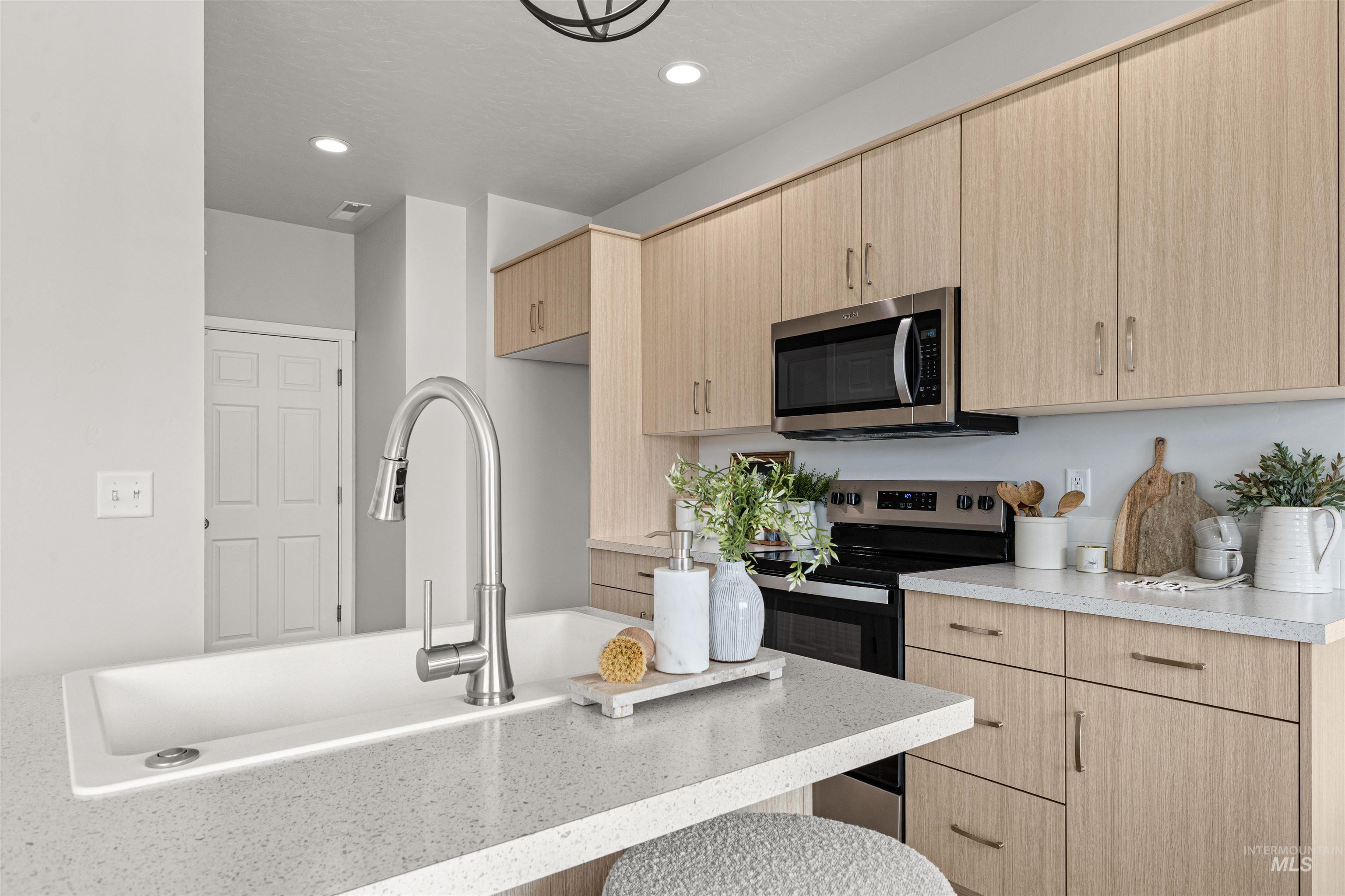 2526 West Fallon Loop Nampa, ID 83651 - Photo 13 of 32 Kitchen with light wood finish cabinetry, stainless steel appliances, recessed lighting, and modern cabinets