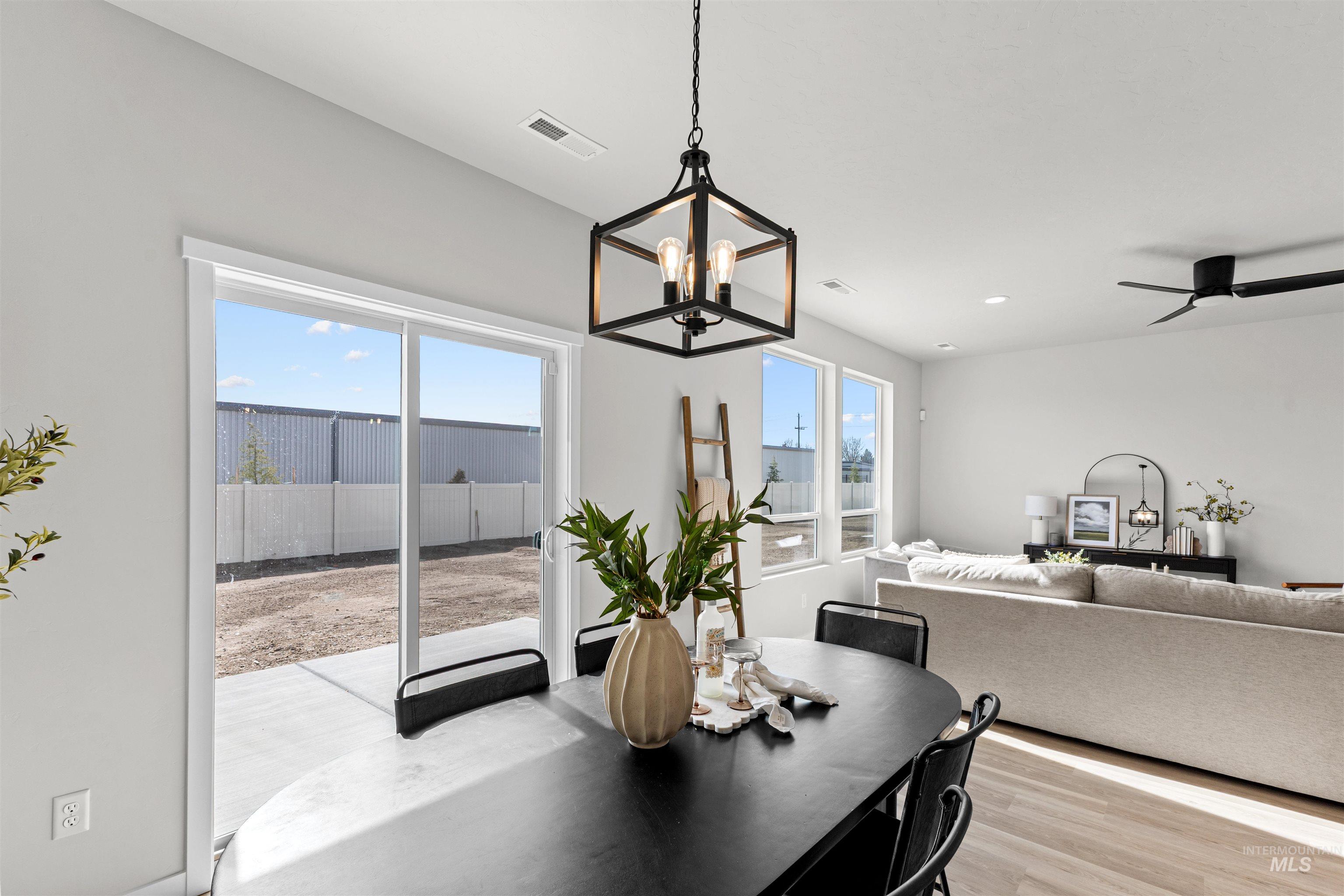2526 West Fallon Loop Nampa, ID 83651 - Photo 16 of 32 Dining space featuring a chandelier, light wood finished floors, and ceiling fan