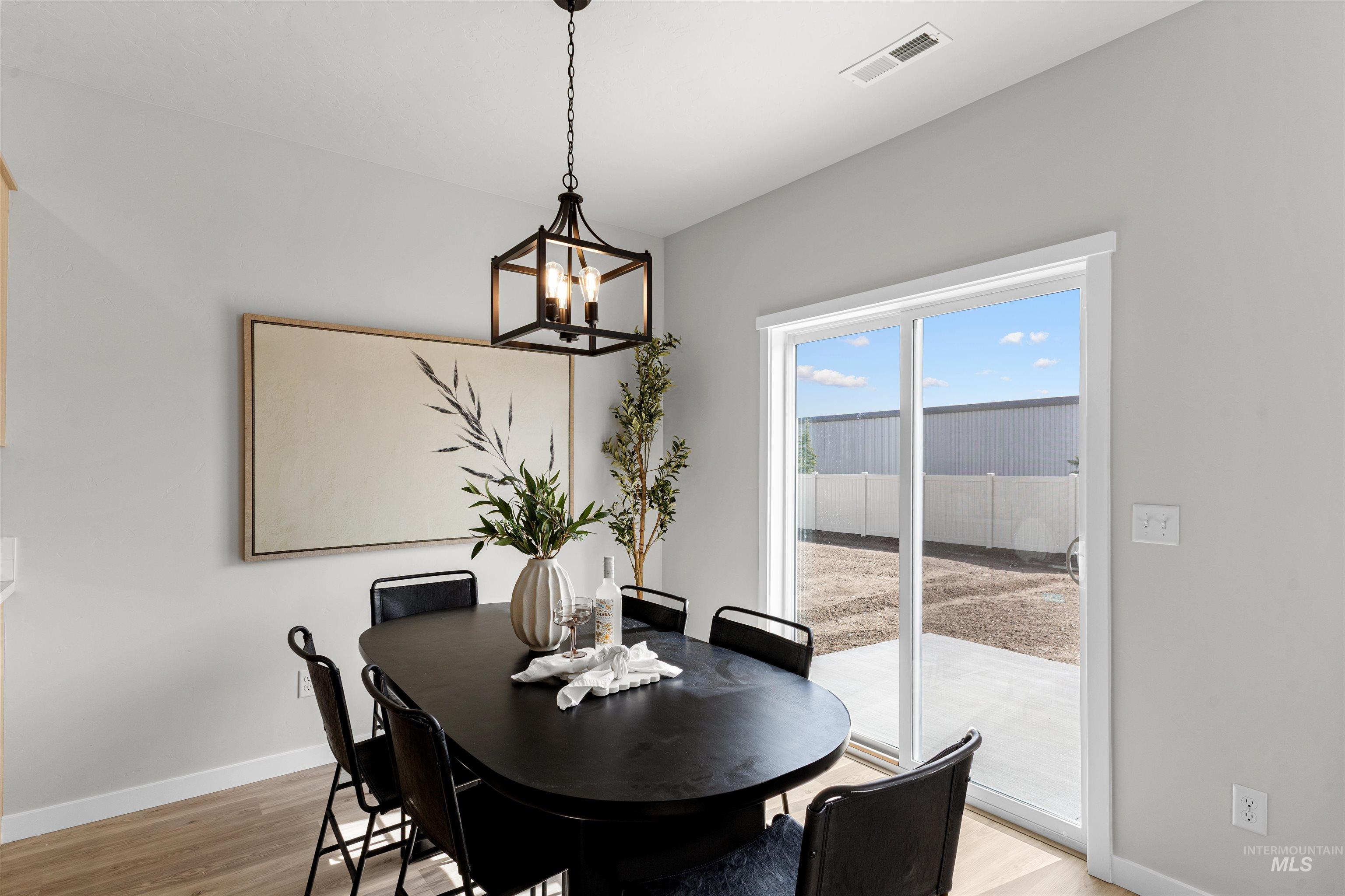 2526 West Fallon Loop Nampa, ID 83651 - Photo 17 of 32 Dining room with light wood-style flooring and a chandelier