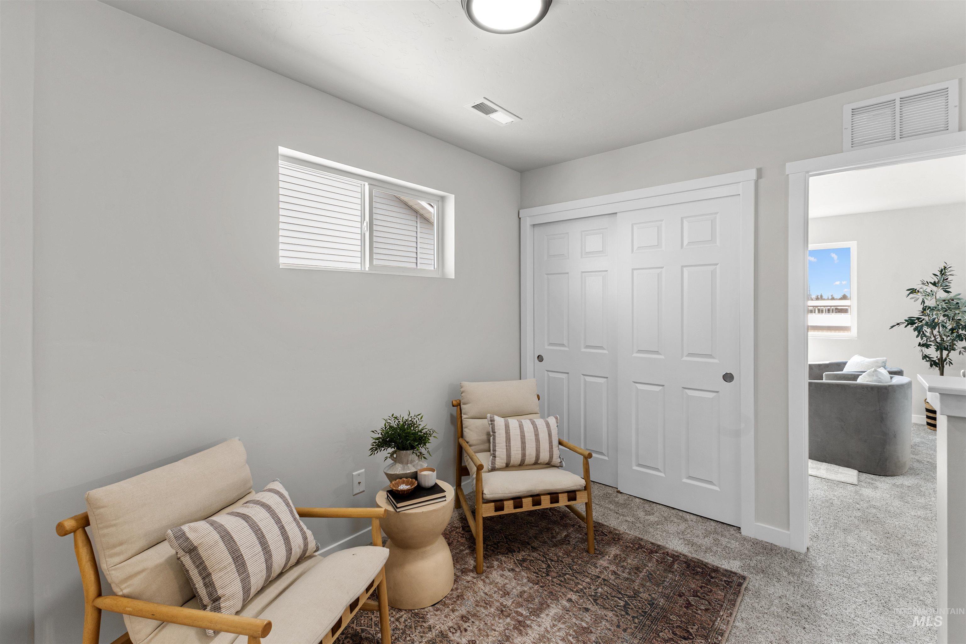 2526 West Fallon Loop Nampa, ID 83651 - Photo 21 of 32 Living area with light colored carpet and baseboards