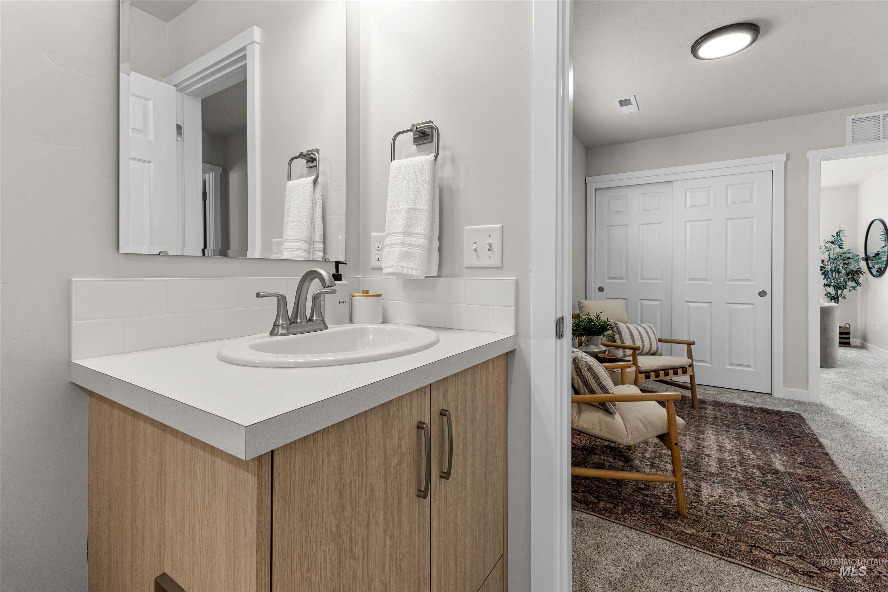 2526 West Fallon Loop Nampa, ID 83651 - Photo 27 of 32 Half bath featuring vanity and light carpet