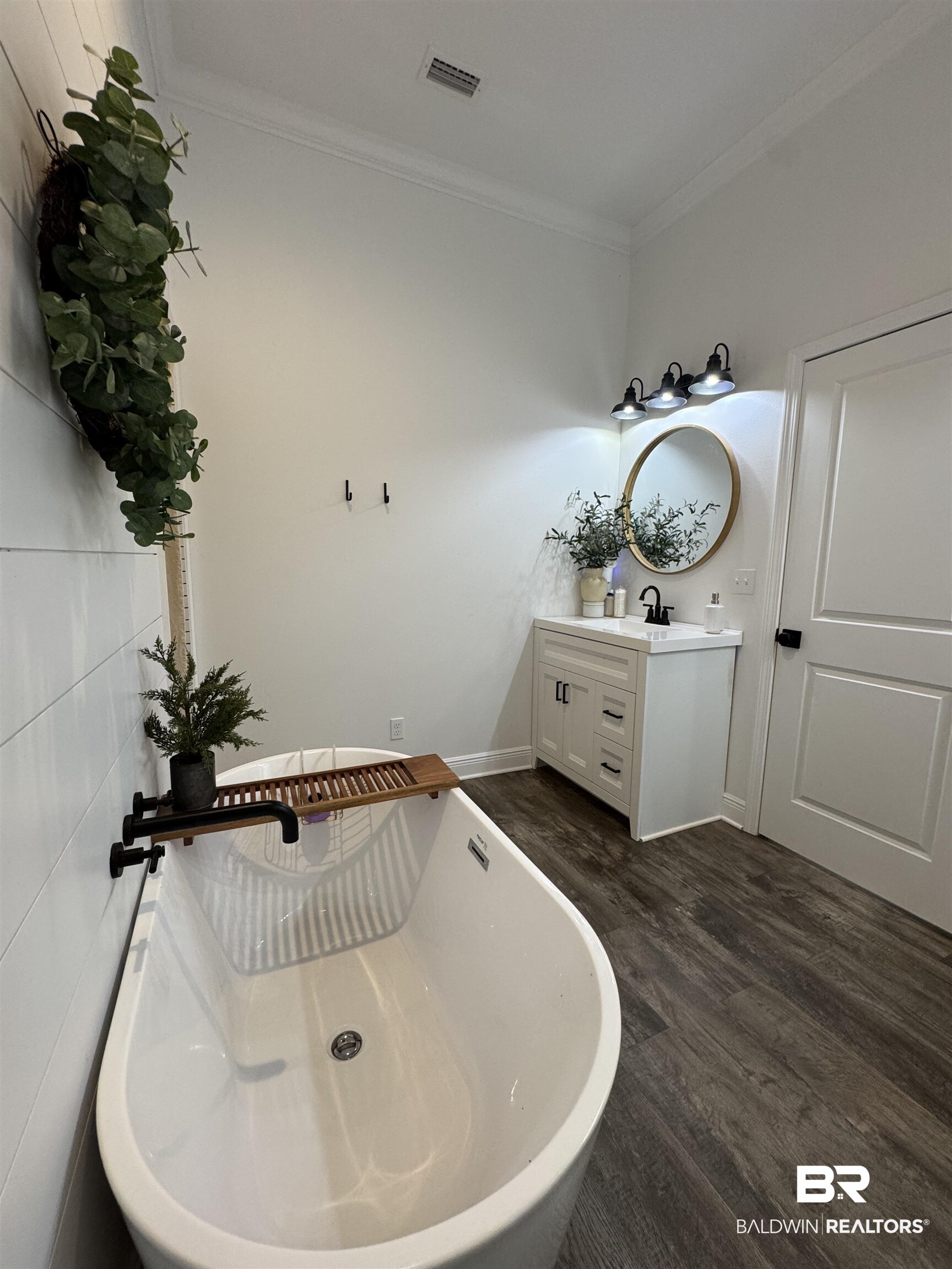 370 Dianne Road Frisco City, AL 36445 - Photo 35 of 41 Bathroom featuring a bath, tile walls, wood-type flooring, crown molding, and vanity