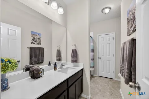 a bathroom with a double vanity sink and a mirror
