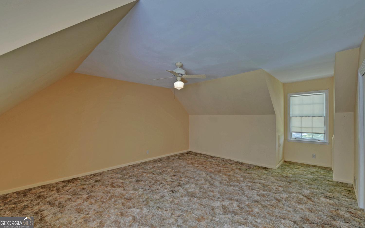 400 Harris Street Toccoa, GA 30577 - Photo 33 of 49 an empty room with windows and ceiling fan view