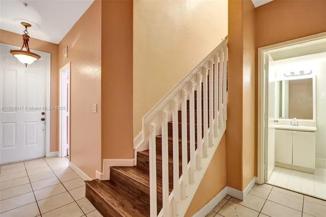 a white toilet sitting next to a bathroom sink