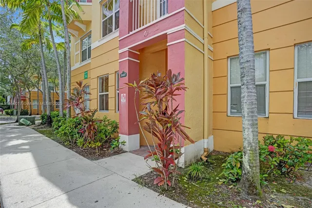 front view of a brick house with a yard