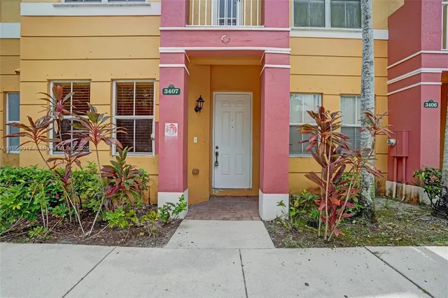 an aerial view of a city with lots of residential buildings ocean and mountain view