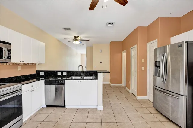 a view of a kitchen with an empty space and a window
