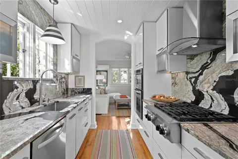a kitchen with stainless steel appliances a refrigerator and a stove top oven