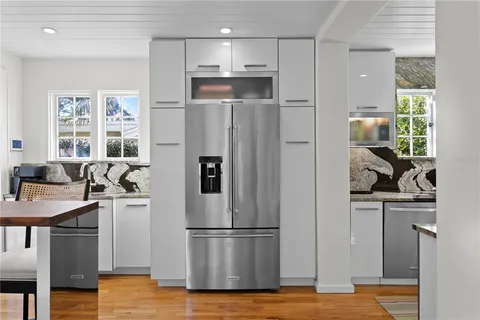 a view of a a dining room with furniture window and wooden floor