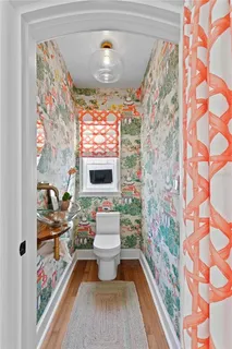 a view of a white house with a yard patio and fire pit