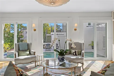 a dining room with furniture potted plants and wooden floor