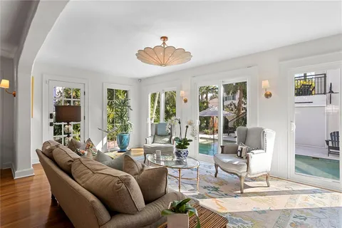 a view of a dining room with furniture and chandelier