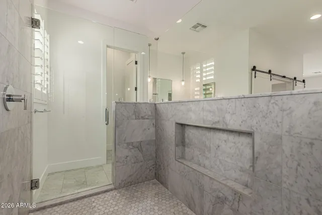 a bathroom with a tub a sink and mirrors