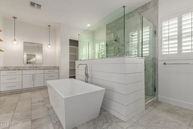 a bathroom with a tub sink and mirror