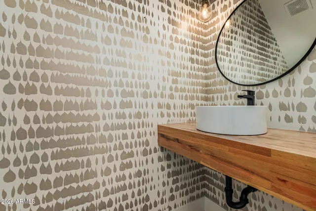 a kitchen with stainless steel appliances granite countertop a sink a stove and a wooden floors