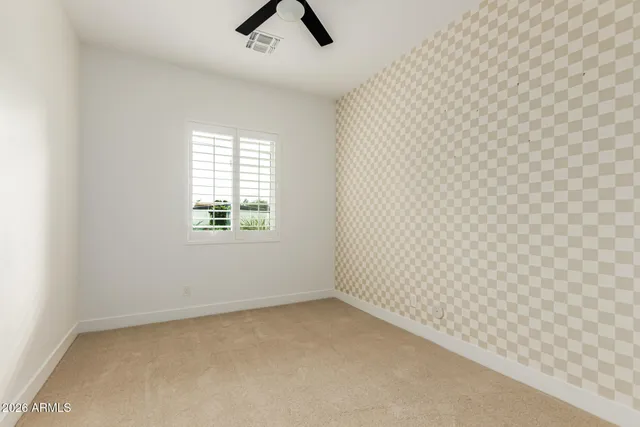 a view of empty room with wooden floor and windows