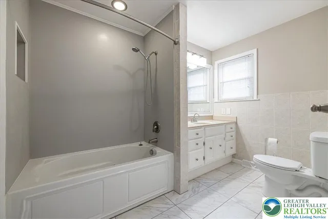 a view of a hallway with wooden shelves