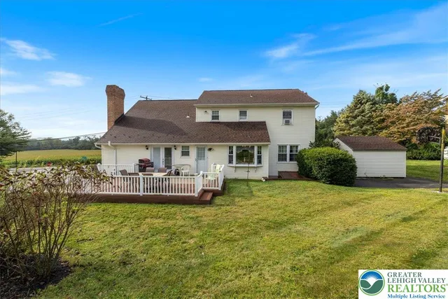 a view of a house with swimming pool and a yard
