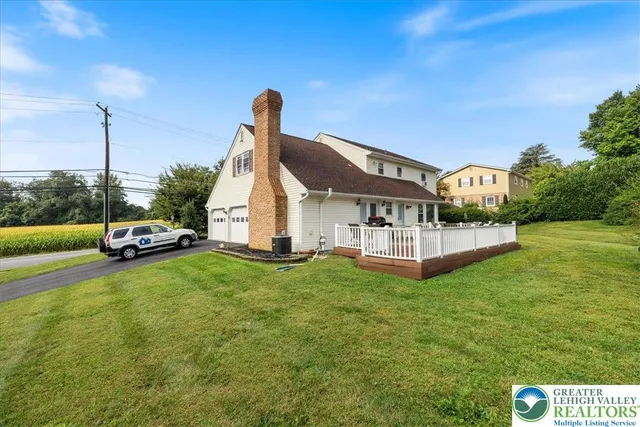 a patio with wooden floor and outdoor seating