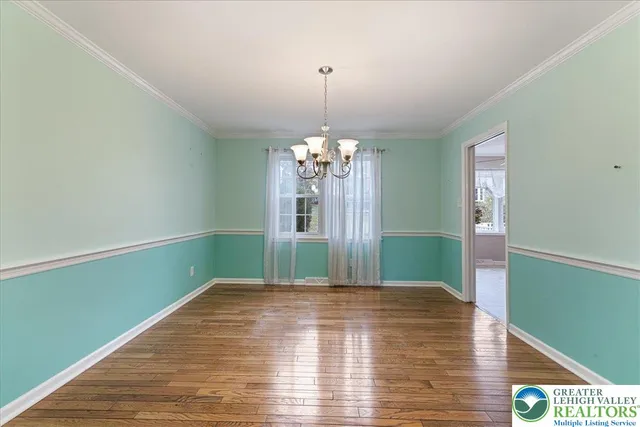 a view of a room with window and wooden floor