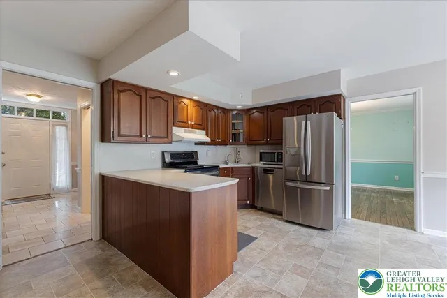a kitchen with a refrigerator and a sink
