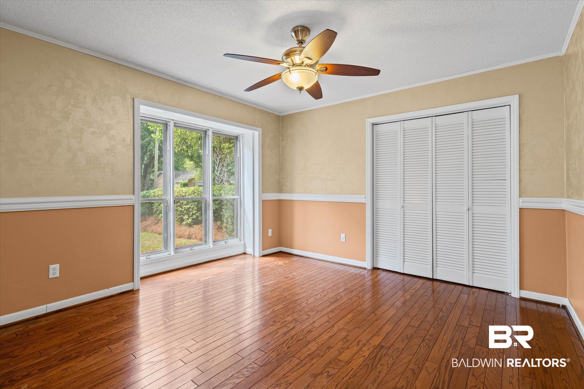 3724 Claridge Road South Mobile, AL 36608 - Photo 17 of 42 Unfurnished bedroom featuring hardwood / wood-style flooring, a textured ceiling, a ceiling fan, a closet, and ornamental molding