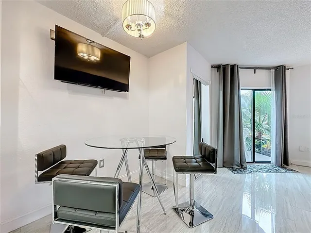 a view of a livingroom with furniture and a flat screen tv