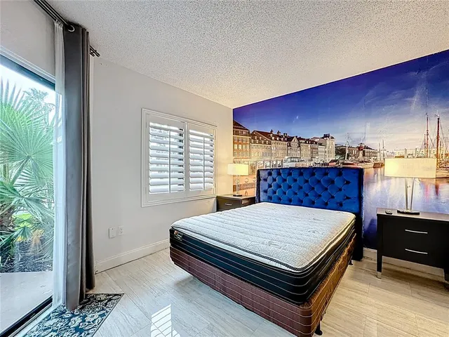 a bed sitting in a bedroom next to a window