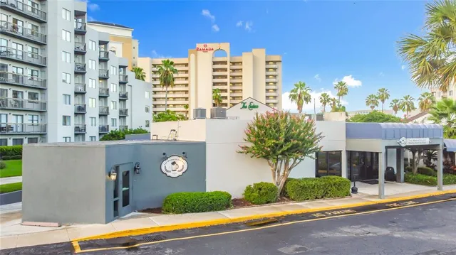 a front view of a house with a yard and potted plants