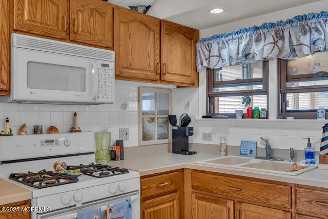 a kitchen with stainless steel appliances granite countertop a stove and a microwave