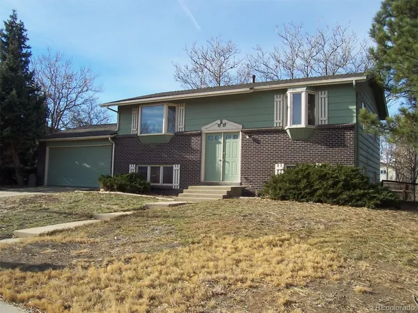 a house that has a tree in front of it