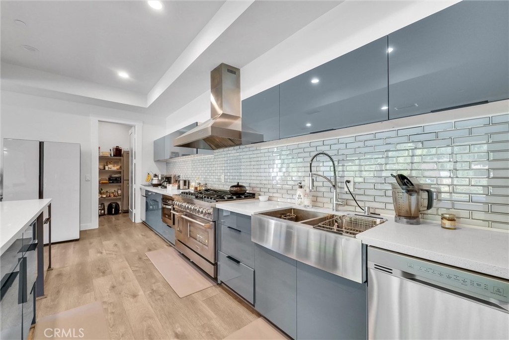 1911 Tumin Road La Habra Heights, CA 90631 - Photo 12 of 43 a kitchen with stainless steel appliances granite countertop a sink stove and refrigerator