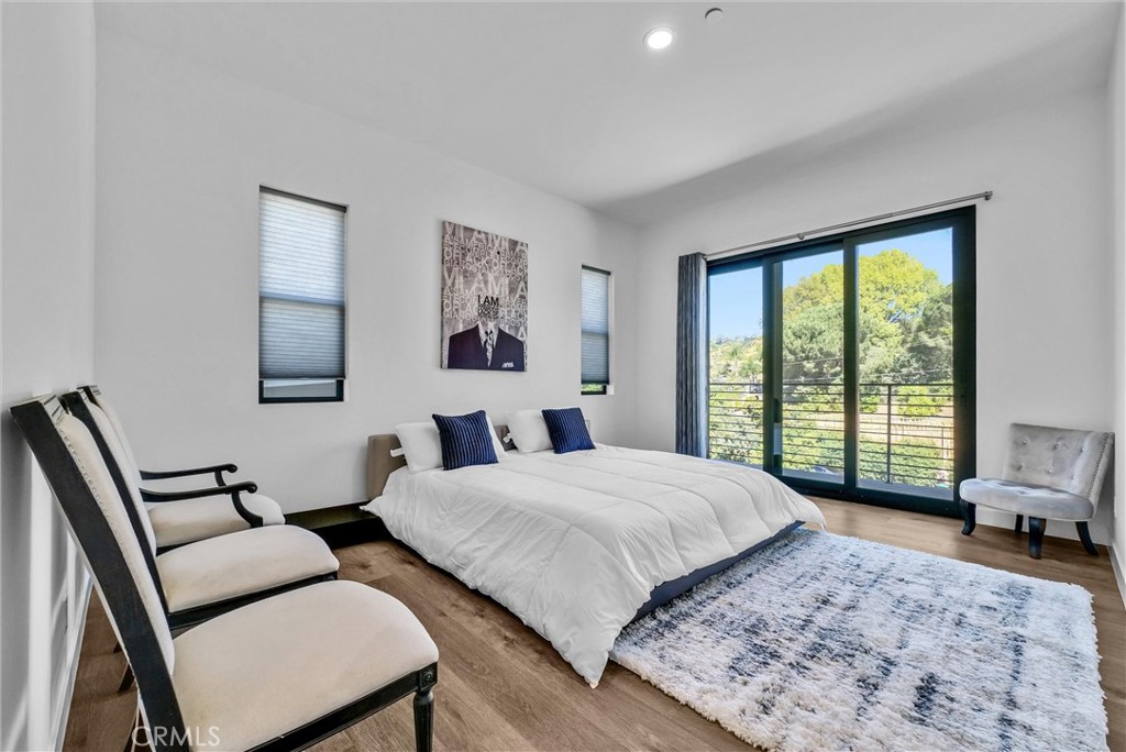1911 Tumin Road La Habra Heights, CA 90631 - Photo 36 of 43 a bedroom with a bed a large window with table and chair