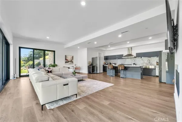 a living room with furniture a rug and a large window
