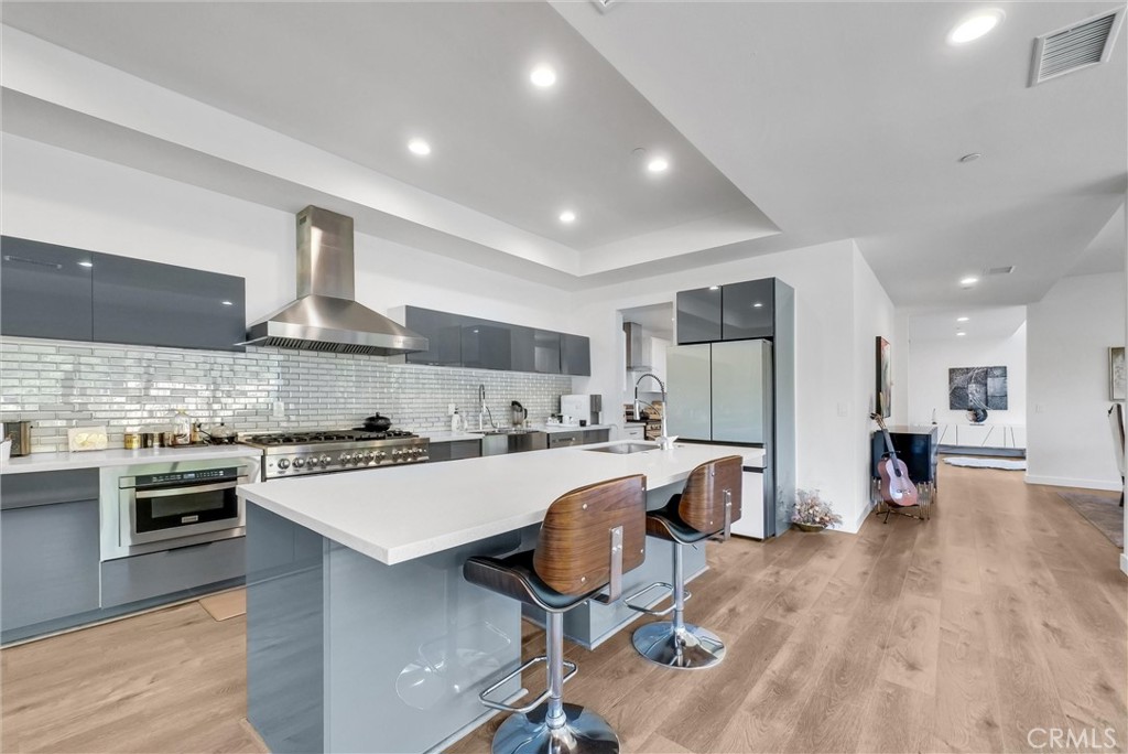 1911 Tumin Road La Habra Heights, CA 90631 - Photo 10 of 43 a kitchen with a sink a stove cabinets and stainless steel appliances