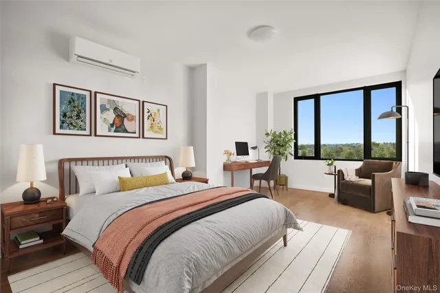 a bedroom with bed and large windows