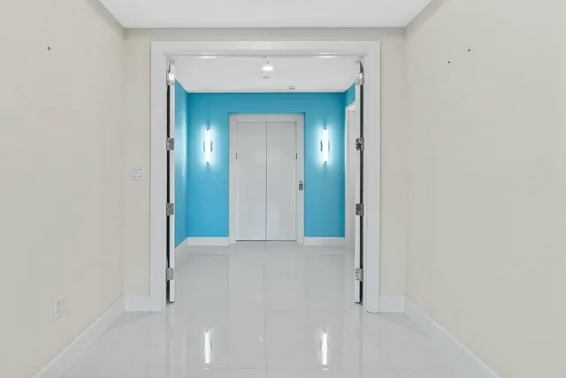 a large white kitchen with granite countertop a large window and a sink