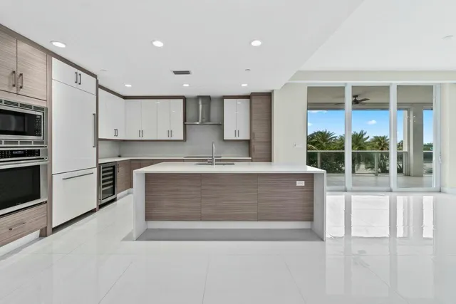 a kitchen with a sink stainless steel appliances and cabinets