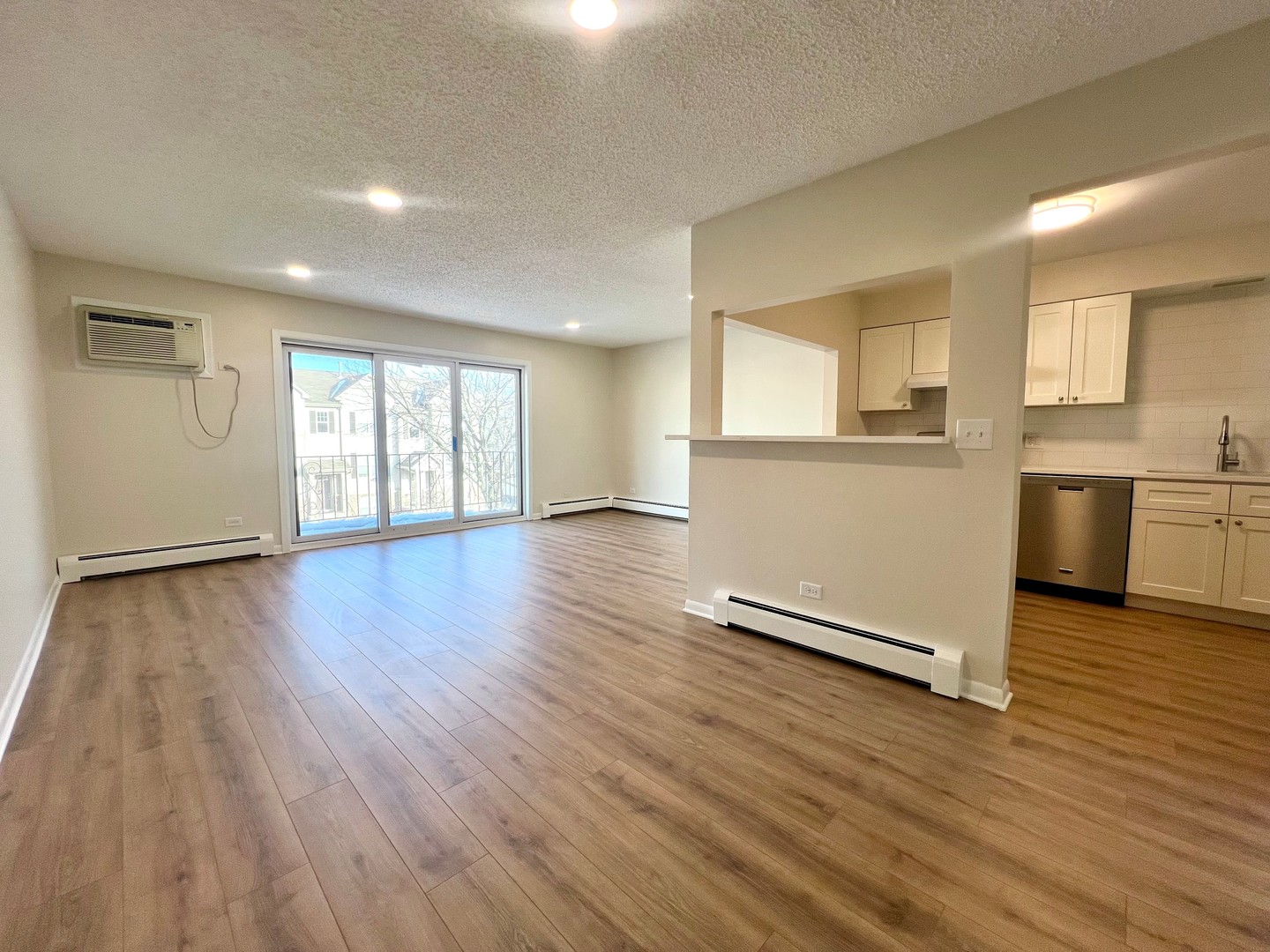 1279 Harding Avenue, Unit 3B Des Plaines, IL 60016 - Photo 6 of 15 an empty room with wooden floor and windows