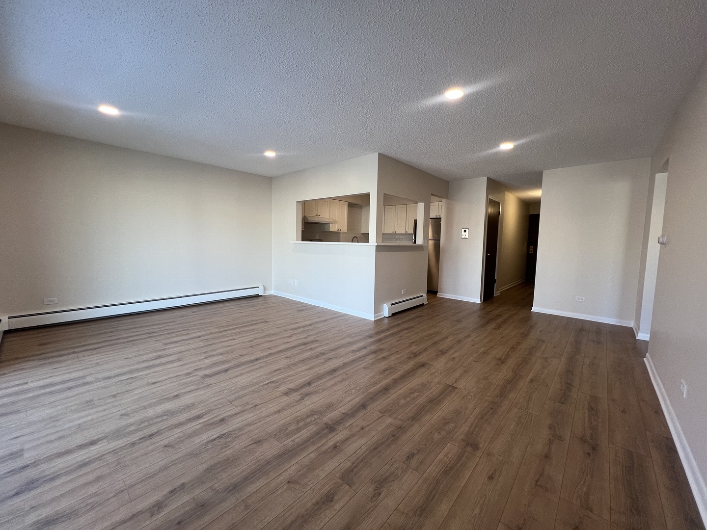 1279 Harding Avenue, Unit 3B Des Plaines, IL 60016 - Photo 7 of 15 a view of a big room with wooden floor and a window