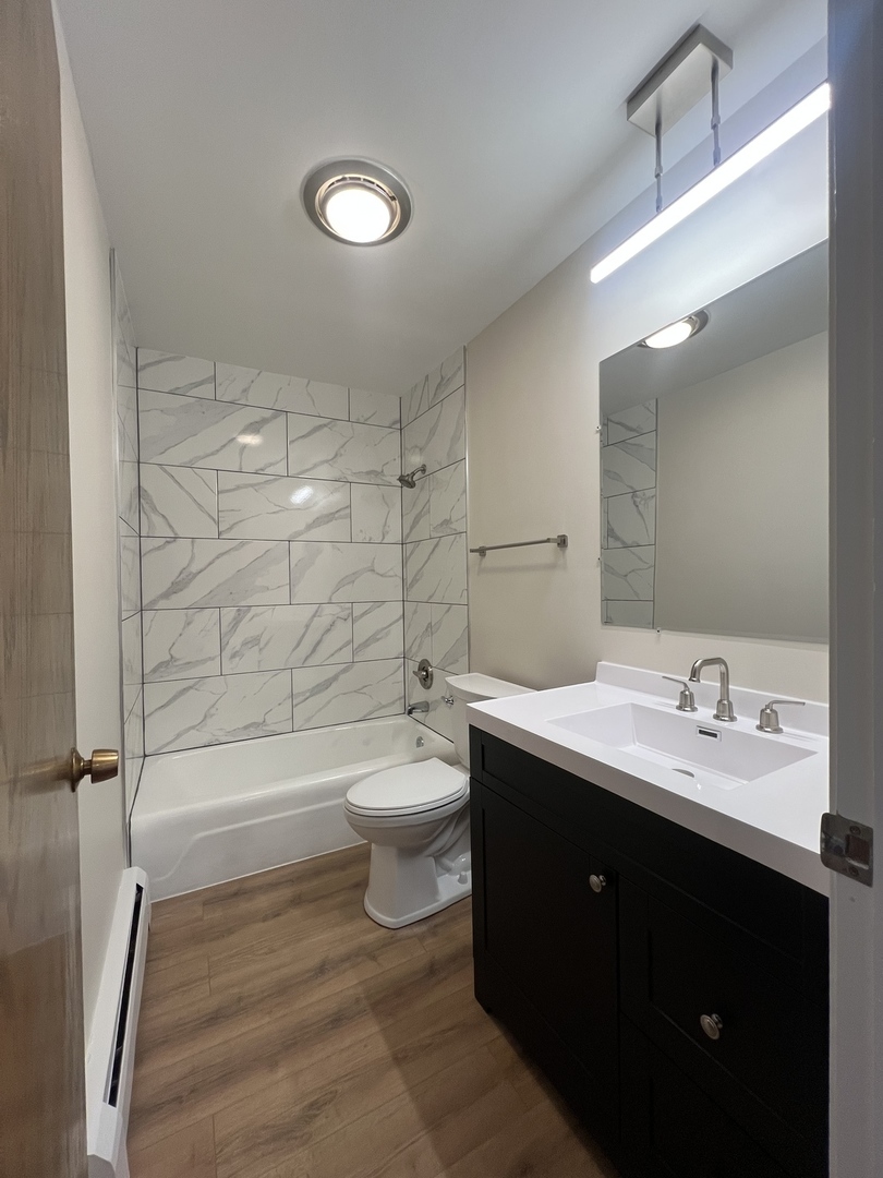1279 Harding Avenue, Unit 3B Des Plaines, IL 60016 - Photo 8 of 15 a bathroom with a double vanity sink toilet and shower