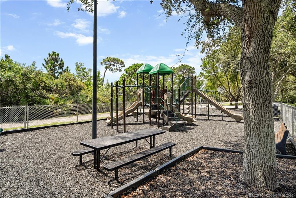 2119 Northwest Marsh Rabbit Lane Jensen Beach, FL 34957 - Photo 3 of 7 a view of a bench in a backyard