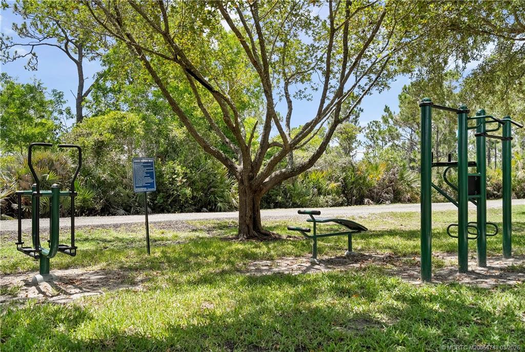 2119 Northwest Marsh Rabbit Lane Jensen Beach, FL 34957 - Photo 7 of 7 a view of a bench in a garden