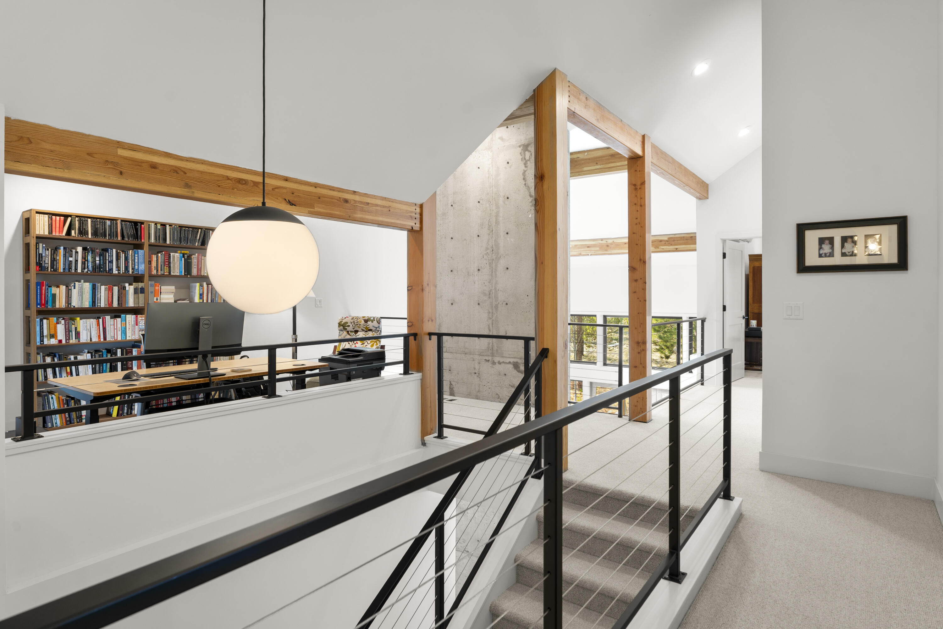 56670 Sunstone Loop, Unit LOT 141 Bend, OR 97707 - Photo 15 of 62 Architecturally striking stairway and upper landing with custom powder-coated metal railing, cable infill, vaulted ceilings, Hibernia Woolen Mills carpet, and a Schoolhouse Electric globe fixture.