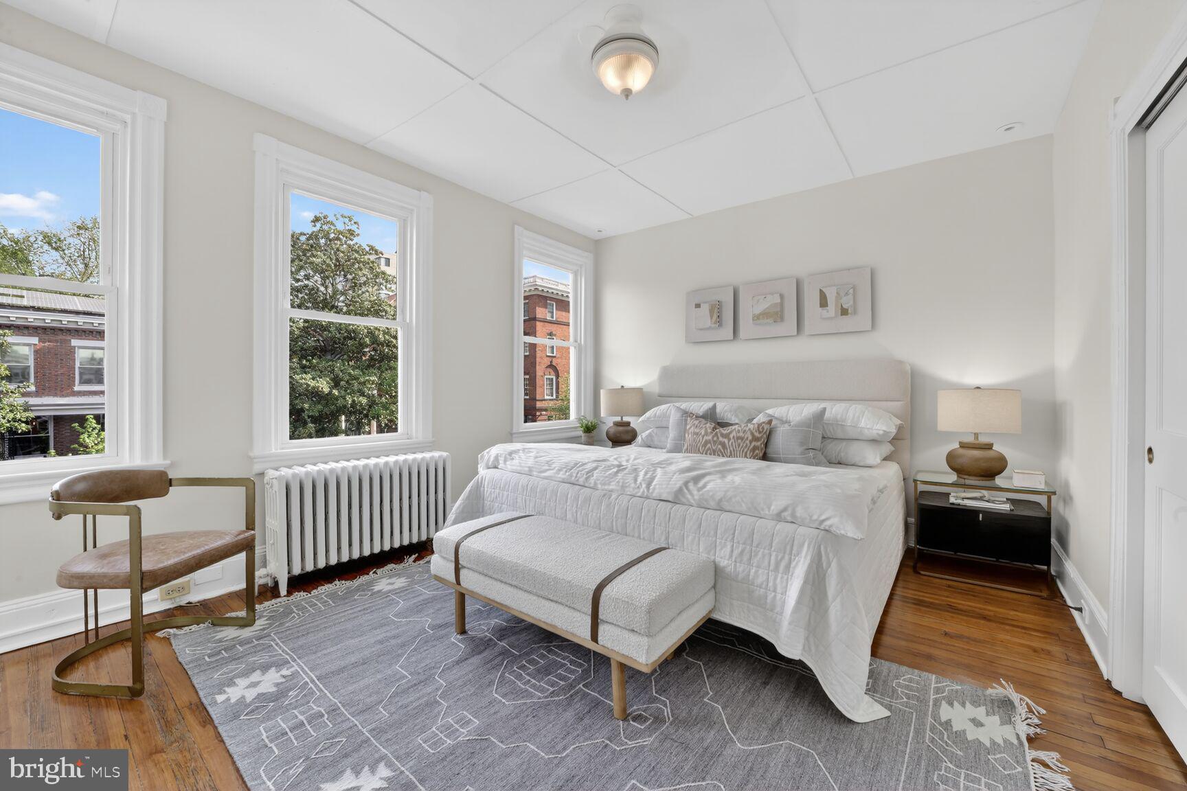 1612 V Street Northwest Washington, DC 20009 - Photo 12 of 29 a spacious bedroom with a bed and a couch